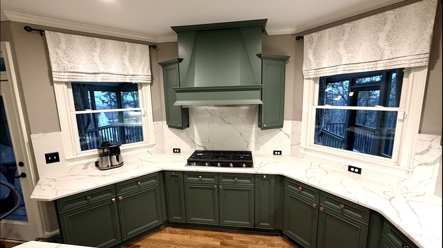 Real finished kitchen with Rosemary-painted cabinets and a marble backsplash, a Cabinet Painting Guys client project