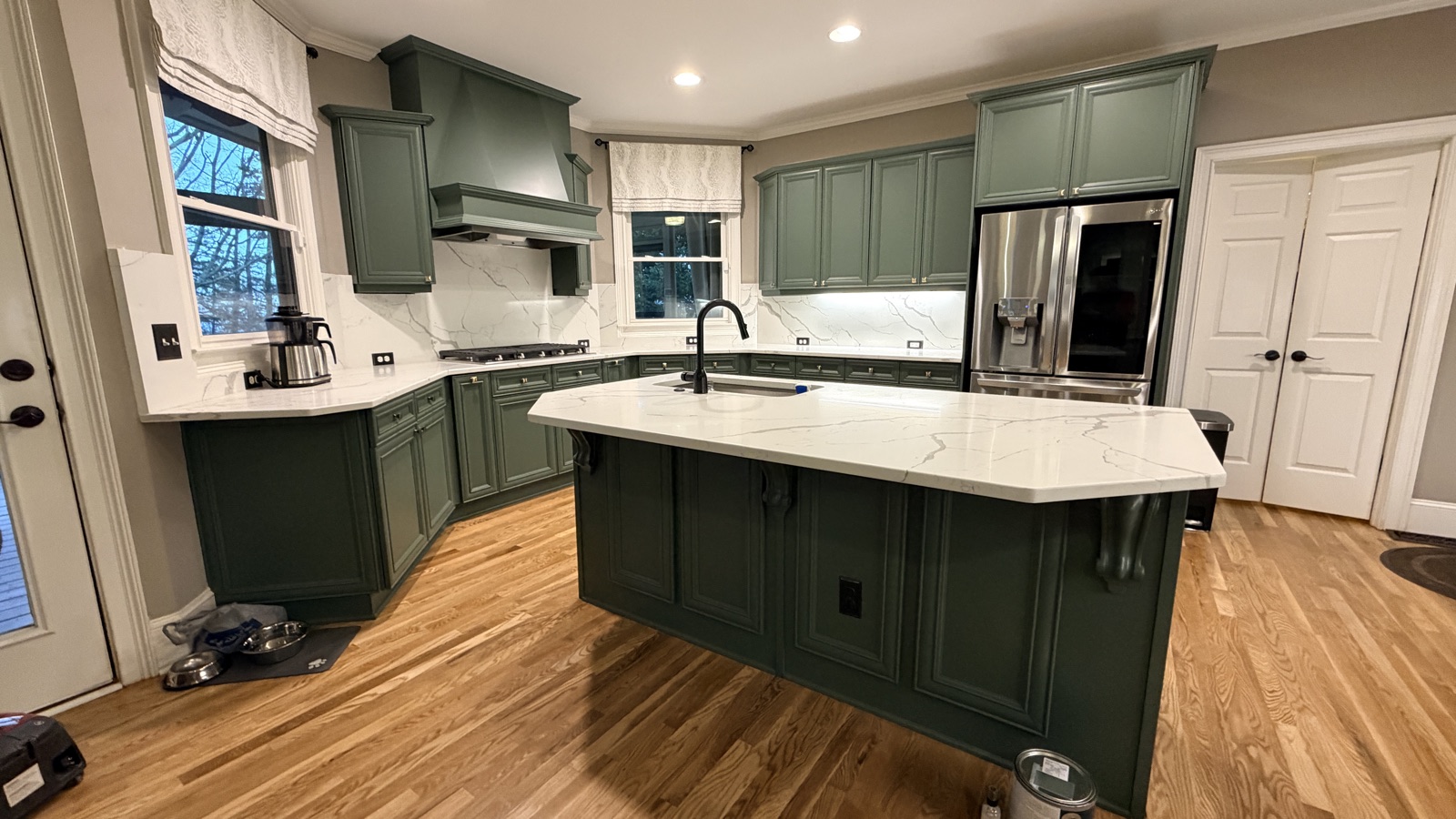 Real finished kitchen island with Rosemary green cabinets, a Cabinet Painting Guys client job