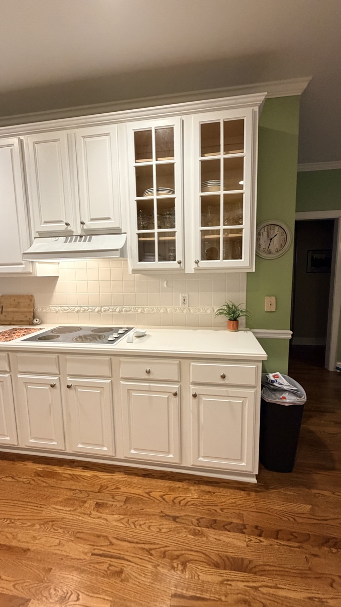 Real finished kitchen with White Flour painted cabinets and glass-front uppers, a Cabinet Painting Guys client job